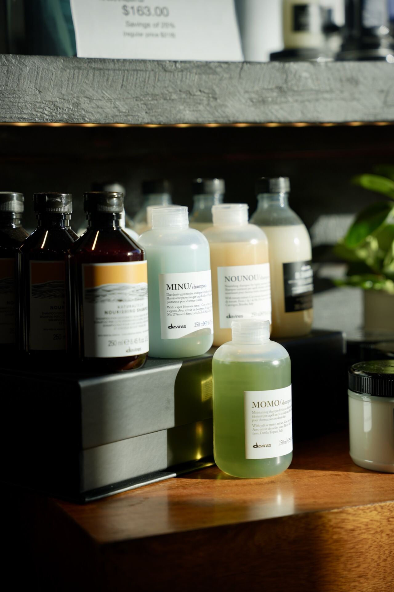 A row of hair care bottles on the retail shelf