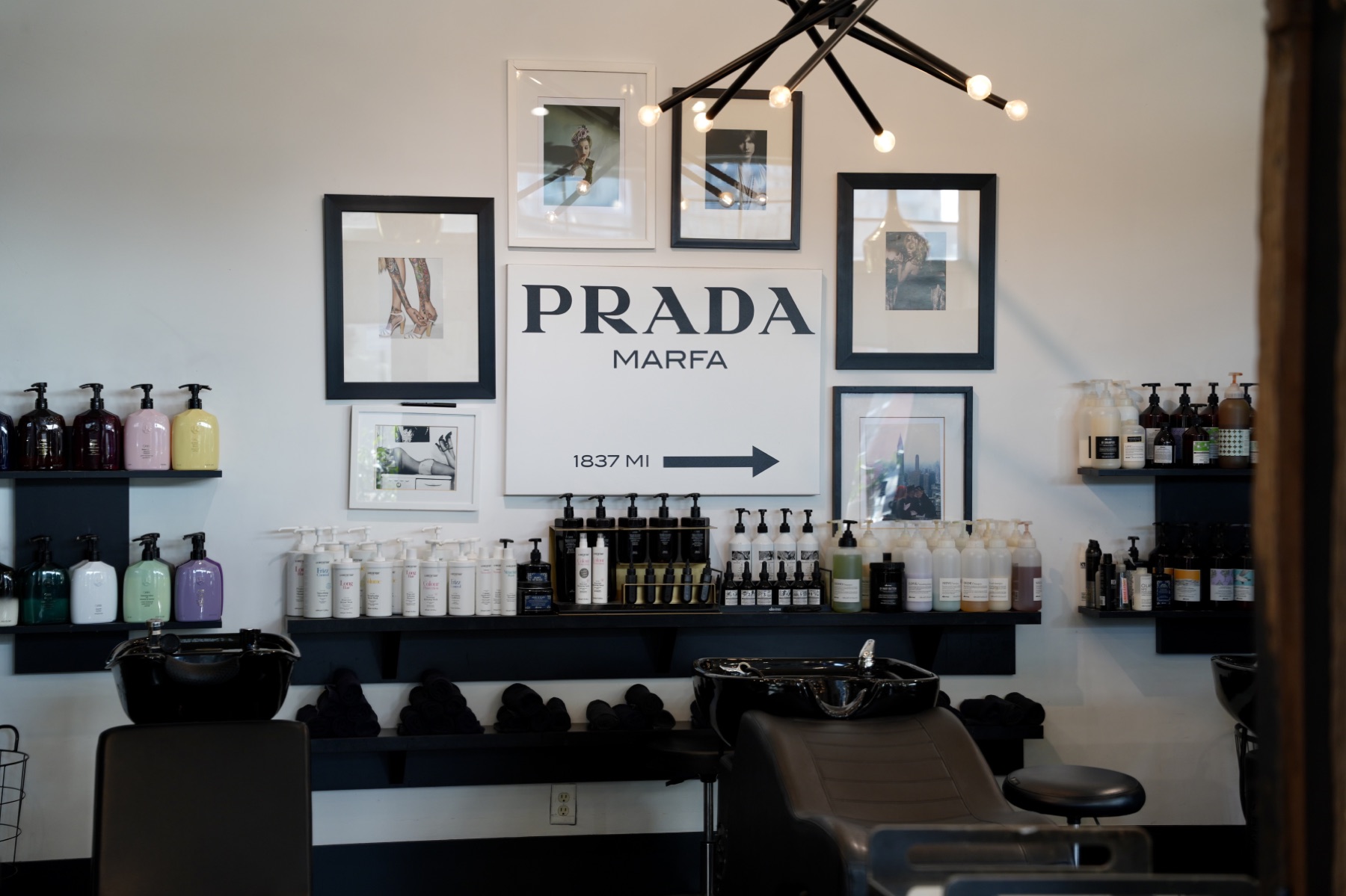 Best Kelowna Hair Salon: Framed prints and product shelves above the shampoo stations