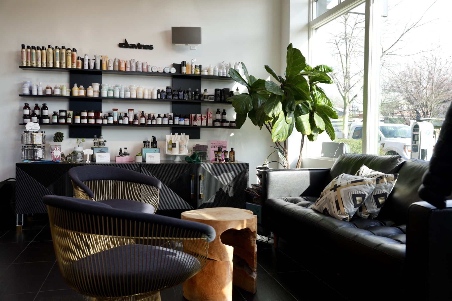 Best Kelowna Hair Salon: Retail wall of hair care products beside the guest lounge