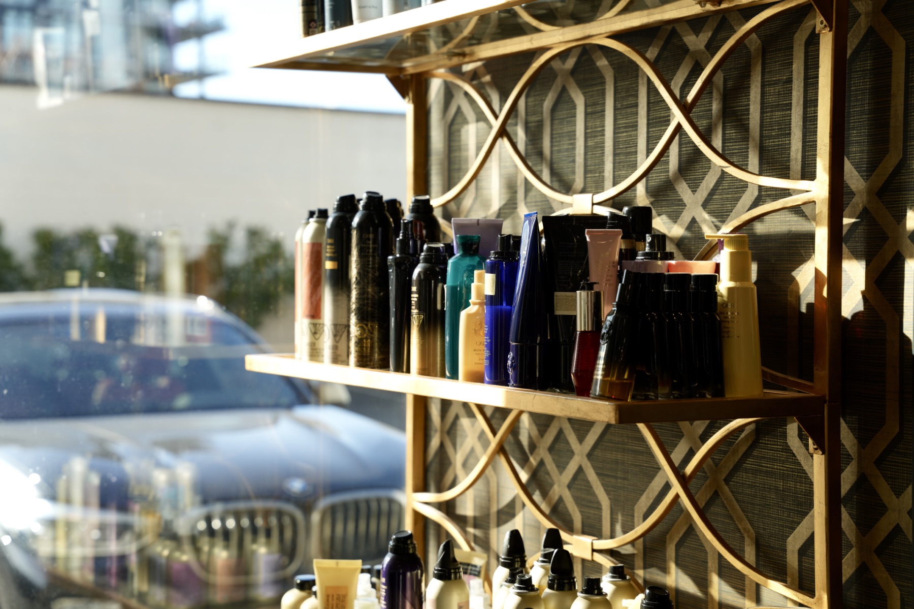 Hair products displayed on a gold lattice shelf at MOD Salon in Kelowna