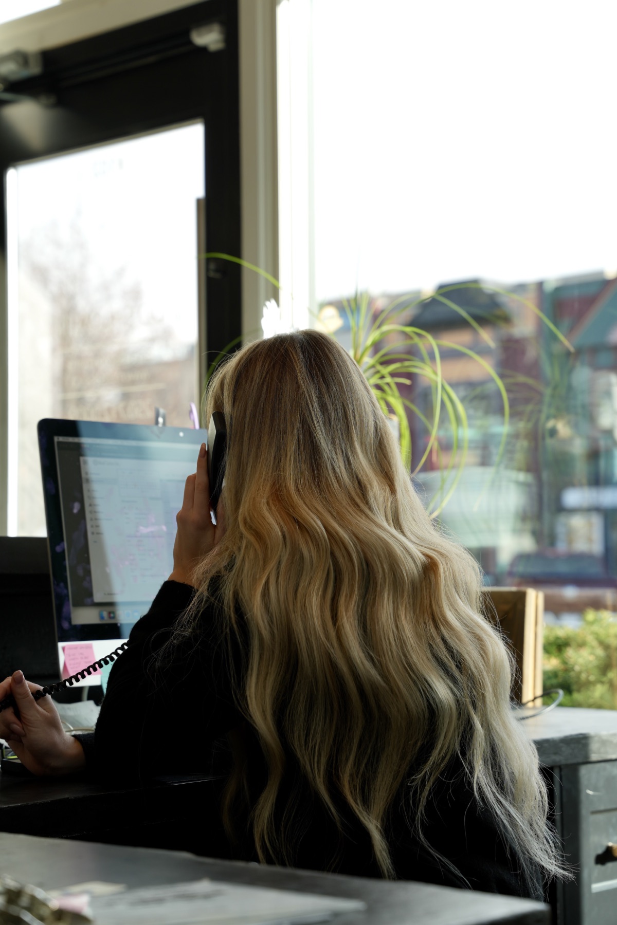 Best Kelowna Hair Salon: Team member answering the phone at the front desk