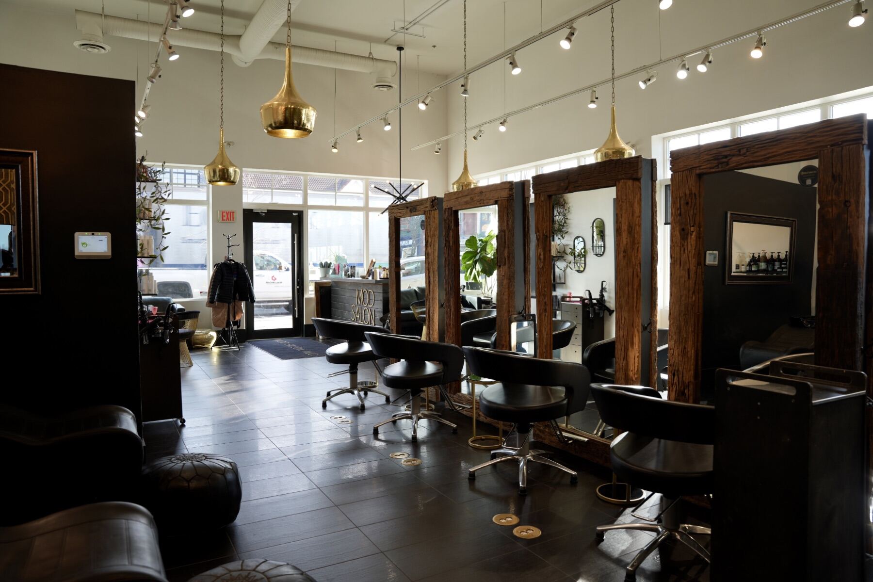 MOD Salon interior with styling stations, mirrors, and pendant lighting in Kelowna