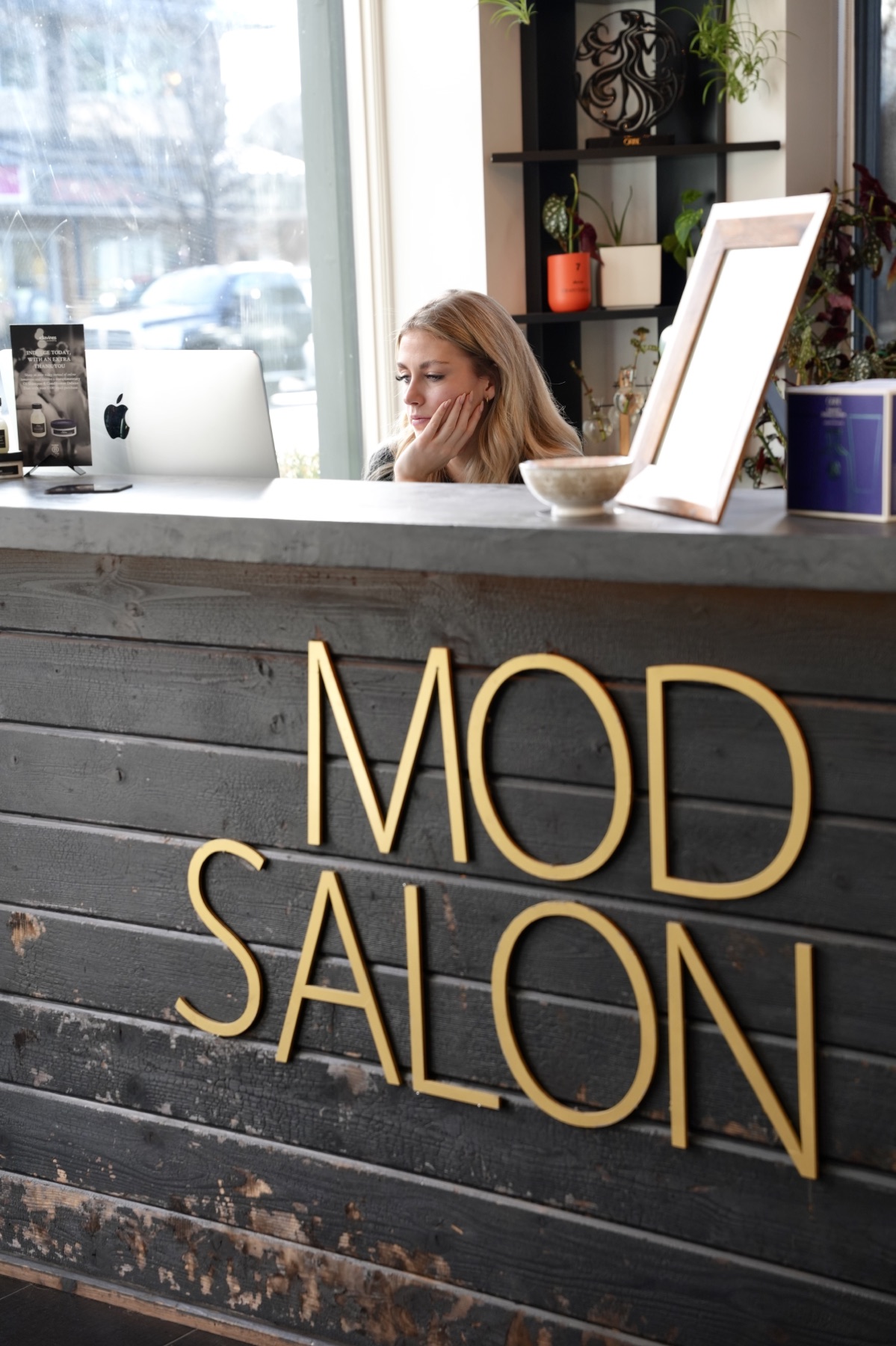 Best Kelowna Hair Salon: Team member working behind the MOD Salon reception desk